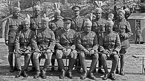 A black and white photograph of Members of the Royal Indian Army Service Corps (RIASC), a part of the British Indian Army, posing for a photo in 1942