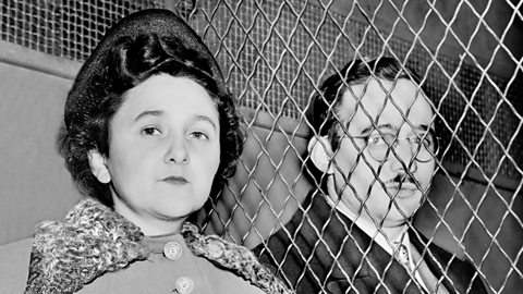 A photograph of Julius and Ethel Rosenberg. There are metal bars between them.