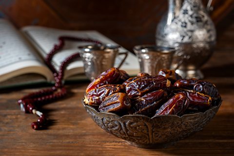 Dried dates in a small bowl.