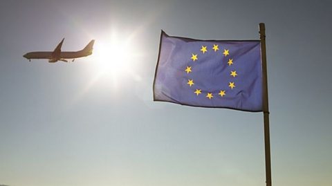 Awyren yn hedfan heibio baner yr UE.