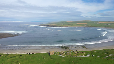 This is a view of Skara Brae looking out to sea over the Bay of Skaill.