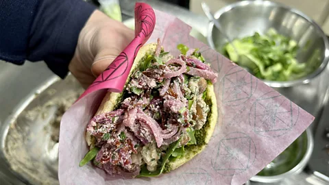 Sarah Freeman At Barbaresgan, people queue for mchadi (a fried corn bread) stuffed with red bean and eggplant pkhal (Credit: Sarah Freeman)