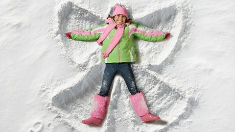 A child making a snow angel.