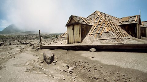 An image of a destroyed property covered in ash