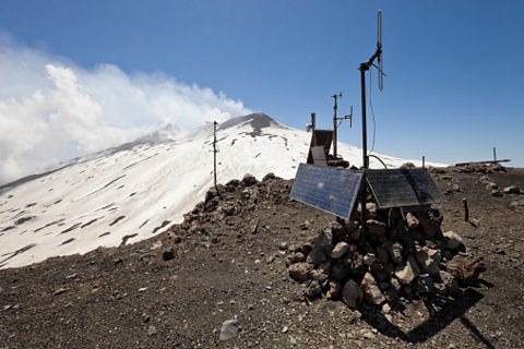 A piece of machinery with solar panels on the side of a snowy mountain.