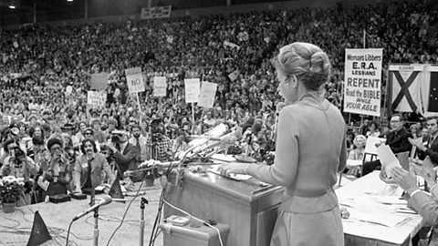 A photograph of Phyllis Schlafly addressing a large audience