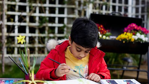 An image of a boy painting. 