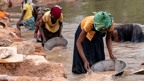 J.Kannah/Getty Images Artisanal miners collect gravel from the Lukushi river searching for cassiterite – the major ore of tin – in Manono, Democratic Republic of Congo (Credit: J.Kannah/Getty Images)