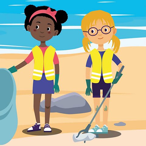 A picture of two girls picking up rubbish on the beach