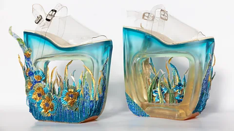Guo Pei/ Legion of Honor/ Fine Arts Museum, San Francisco Towering, futuristic shoes of clear resin by Guo feature floral embroidery (Credit: Guo Pei/ Legion of Honor/ Fine Arts Museum, San Francisco)