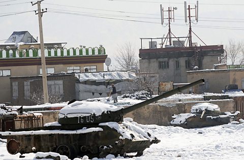 A tank in a city covered in snow