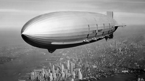 An airship in the sky over New York.