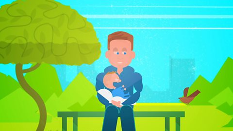 A dad sits on a bench in a park and holds his baby. He is animated, a screenshot from the animation on this page.