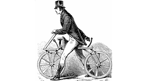 A drawing of a man in a top hat riding a draisine bicycle.