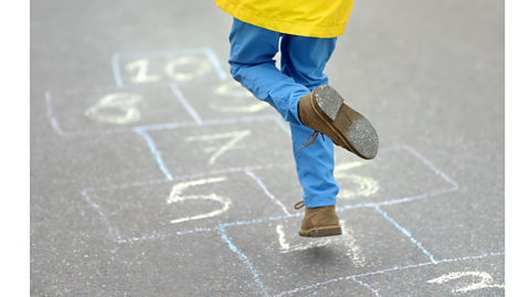 A child playing hopscotch.