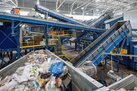 A waste sorting plant with different conveyor belts carrying household waste.