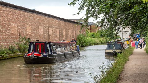 Canal boat heading down a canal