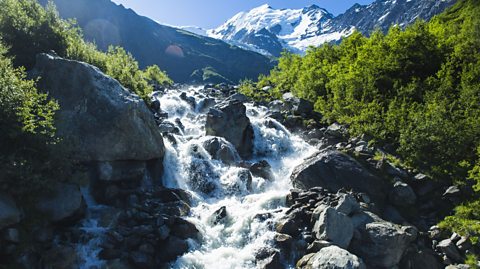 A waterfall fed by glacial meltwater in the French Alps.