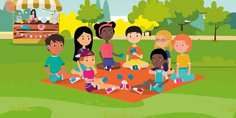 A group of children sat having a picnic