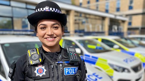 Anokhi in uniform stood outside the police station.