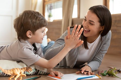 Parent and child high five.