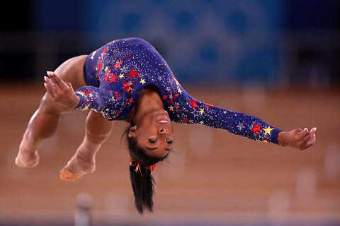 American gymnast Simone Biles performing a flip.