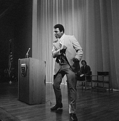 Muhammad Ali demonstrates the Ali Shuffle during a talk to students at Harvard University.