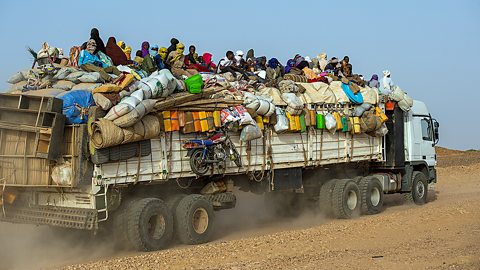 Nigerien workers on a truck crossing the Sahara Desert from Niger north to Libya for work in mines.