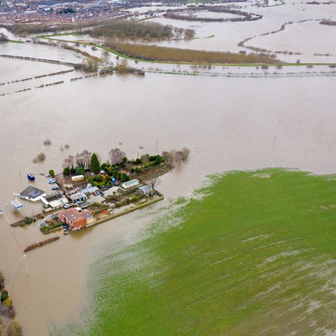 Aerial photo of Allerton Bywater near Leeds showing a house and field surrounded by water after flooding.