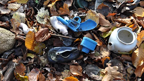 Grzegorz Kiarszys Toy guns have been found in the waste heaps. The square-shaped piece of plastic, which appears to be an ink bottle, is embossed with Cyrillic text (Credit: Grzegorz Kiarszys)