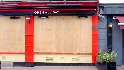 A boarded up shop. 