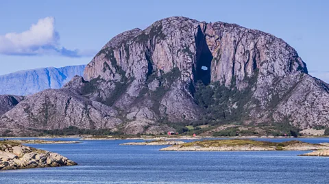 Dag Sundberg/Getty Images Torghatten looms over the route, easily recognised due to its distinctive hole (Credit: Dag Sundberg/Getty Images)
