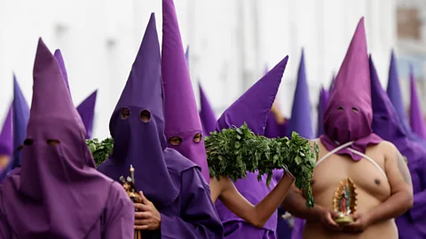 Getty Images The religious procession "Jesus of Great Power" in Ecuador traditionally involves a 'Cucurucho' walking with stinging nettles on their back in penitence (Credit: Getty Images).