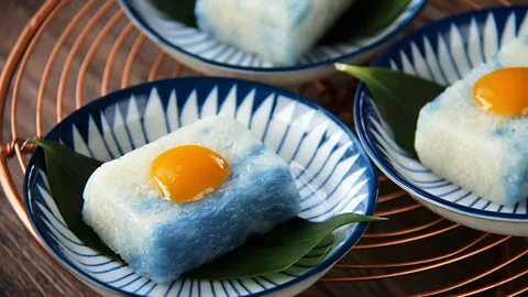 MielPhotos2008/Getty Images Peranakan desserts come in vivid shades of green, brown, yellow and blue (pictured: pulut tai tai) (Credit: MielPhotos2008/Getty Images)
