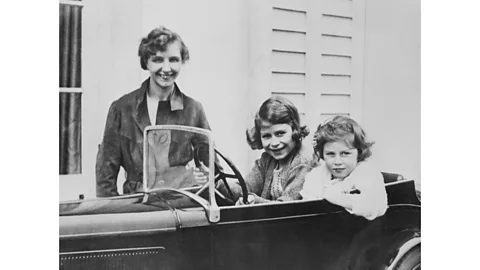 Getty Images The young Princesses Elizabeth and Margaret with their governess, Marion Crawford, whose book The Little Princesses scandalised the palace (Credit: Getty Images)