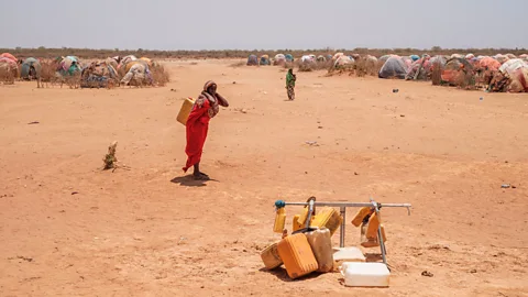 Eduardo Soteras/Getty A woman carries water in Gode, Ethiopia. A devastating famine killed about one million people in Ethiopia in the mid 1980s (Credit: Eduardo Soteras/Getty)