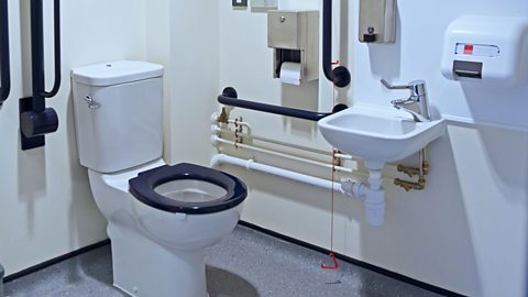 A disabled toilet, sink and hand dryer