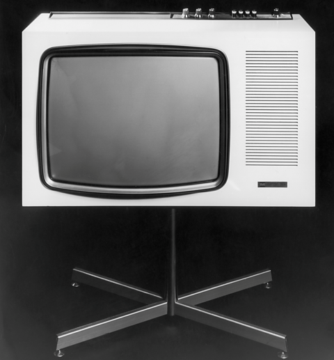 A 1970s colour television on a stand. 