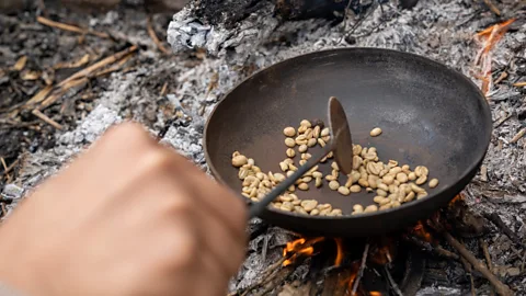 Matt Reichel As we watched, Al-Maliki's sons roasted coffee beans harvested from their fields in a cast-iron pan over an open fire (Credit: Matt Reichel)