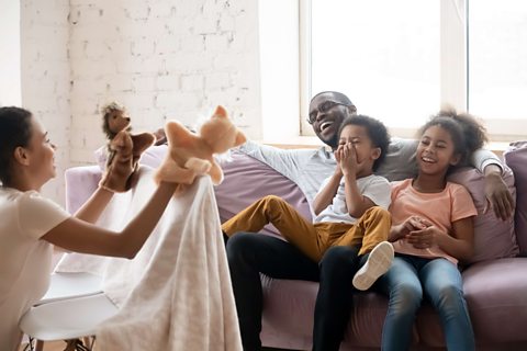 Family play with puppets.