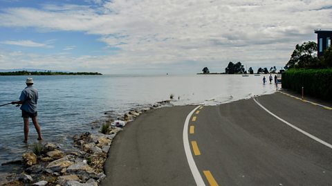 Flooding over a road.