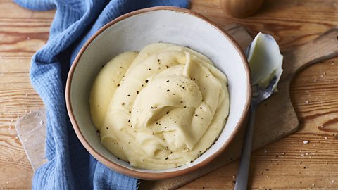 a bowl of fluffy smooth mashed potatoes