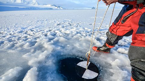 A scientist doing an experiment in Antarctica. 