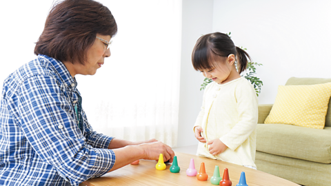 Little girl plays with her grandma.