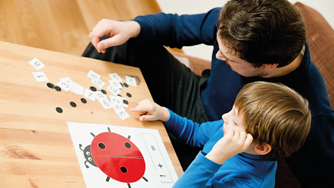 Child and parent playing with numbers.