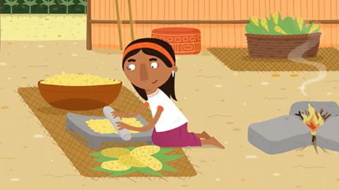 A cartoon of a Maya person grinding corn. 