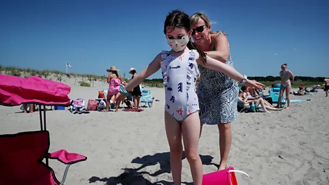 Craig F. Walker/The Boston Globe via Getty Images A beachgoer helps her daughter with sunscreen on Good Harbor Beach in Gloucester, Massachusetts (Credit: Craig F. Walker/The Boston Globe via Getty Images)
