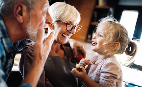 Girl talks to her grandparents.