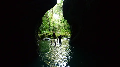 Belize Tourism Board The only way into the ATM Cave is to swim (Credit: Belize Tourism Board)