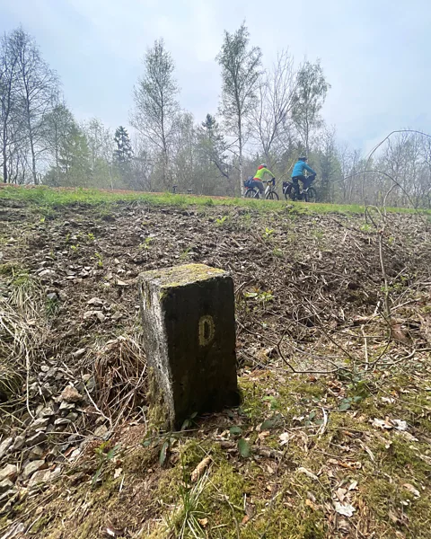 Larry Bleiberg Concrete markers have B on one side and D on the other, abbreviations for Belgium and Deutschland (Credit: Larry Bleiberg)